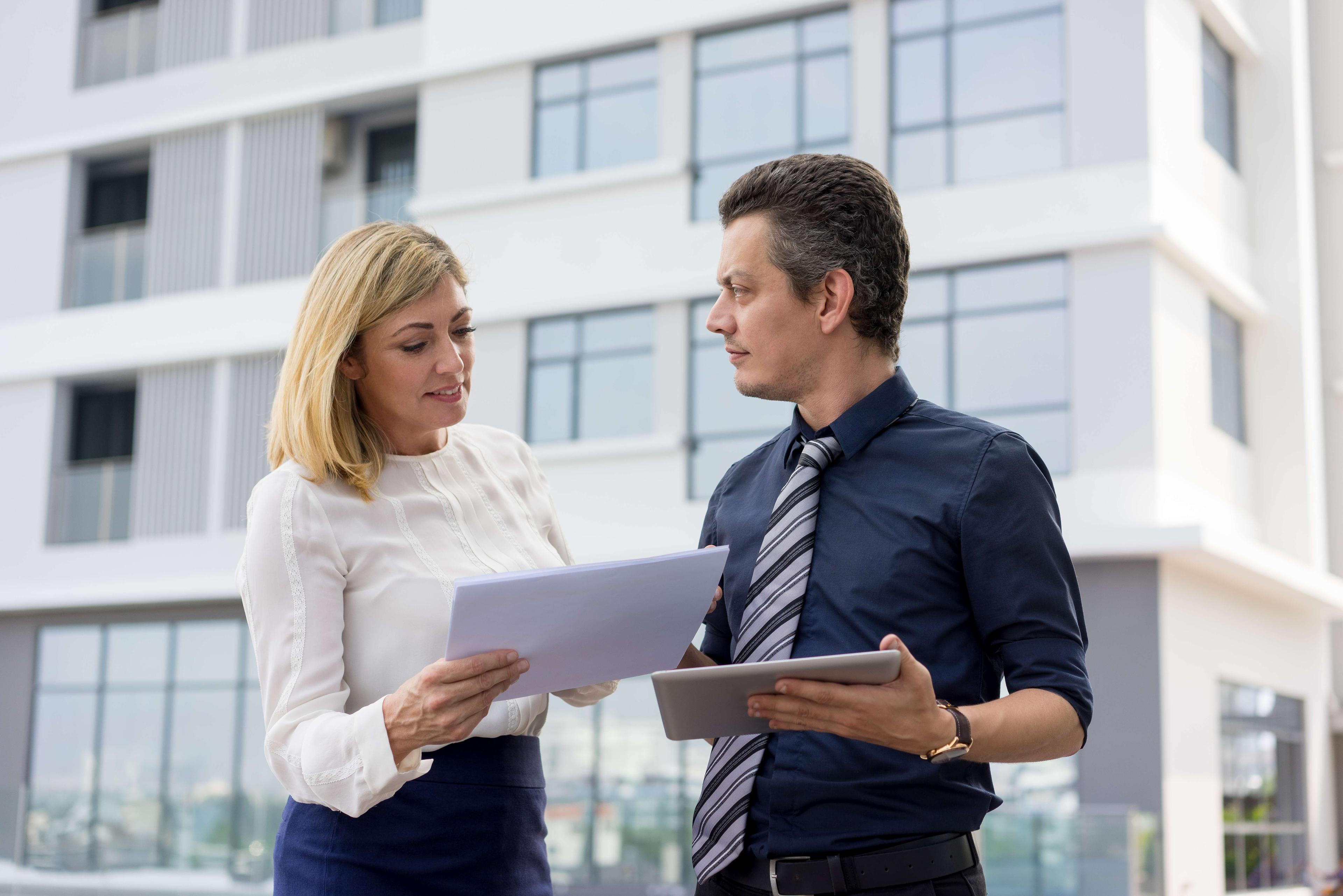 Two people dealing with commercial insurance paperwork
