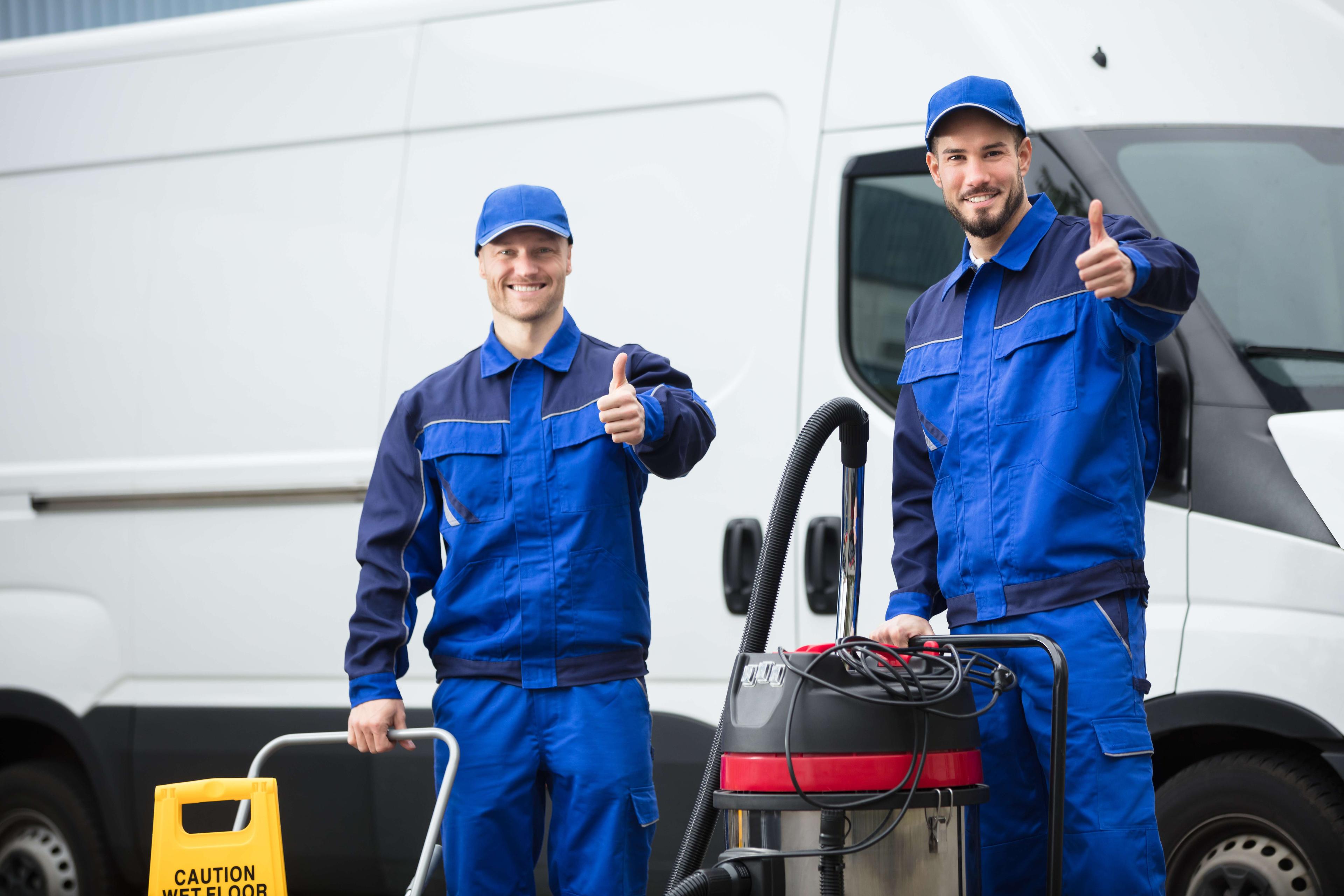 Team of workers in a repair shop working on a vehicle